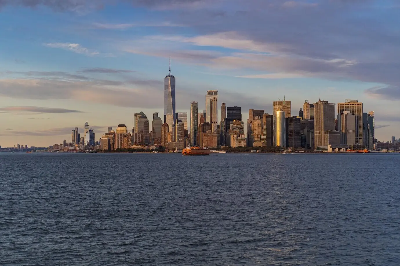 Ferry en route to Manhattan. Manhattan seen from the water at sunset, New York, USA.