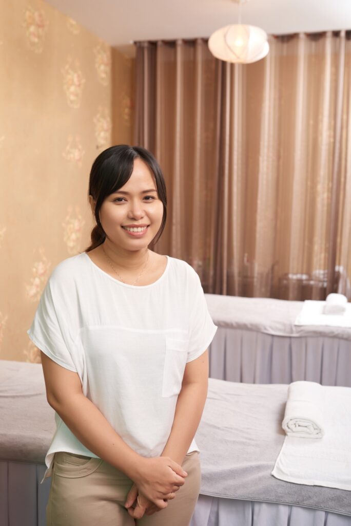 Massage therapist working in spa salon
